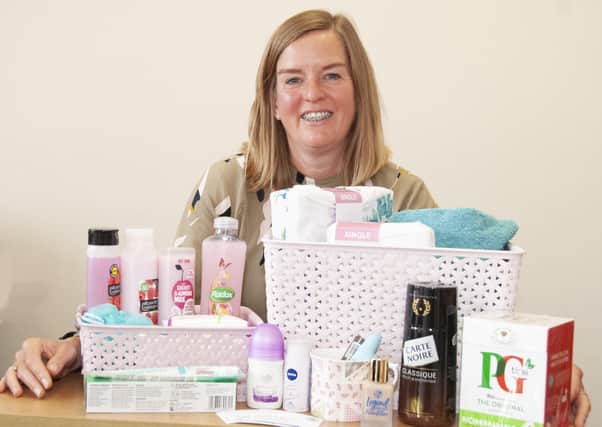 EDAN fundraiser Lucy with one of the packs or pamper hampers
funded by Lincolnshire Freemasons for domestic abuse victims. EMN-200921-133449001