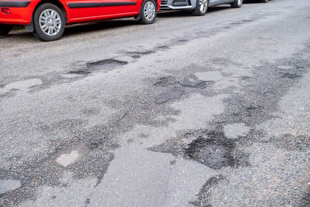 Potholes in Queen Street pictured before repair works.