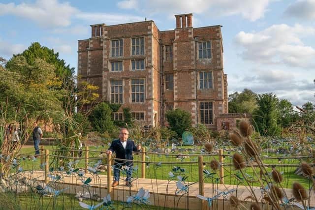Warwick Davis in the gardens with some of the dragonflies