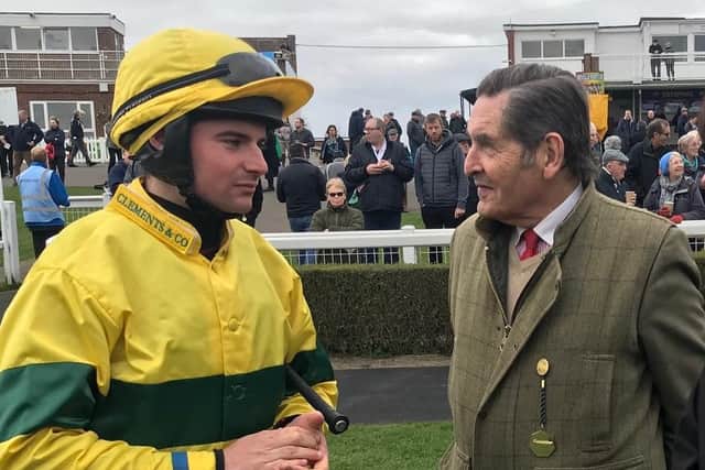 Dr Graham Parry chatting to one of the jockeys at Market Rasen Racecourse
