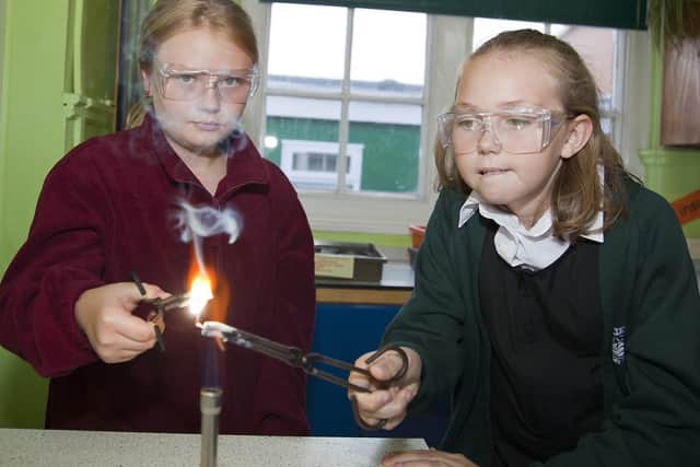 Pictured are Anouska Dobbin, left, and Melissa Sills conducting scientific experiments on burning metal.