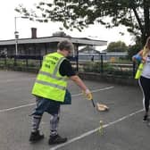 Litter picking in progress on Station Road. EMN-200929-162944001