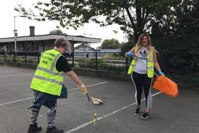 Litter picking in progress on Station Road. EMN-200929-162944001