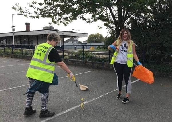 Litter picking in progress on Station Road. EMN-200929-162944001