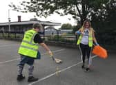 Litter picking in progress on Station Road. EMN-200929-162944001