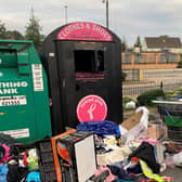 The mess left behind at the clothing recycling bin