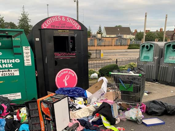 The mess left behind at the clothing recycling bin