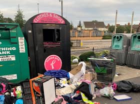 The mess left behind at the clothing recycling bin