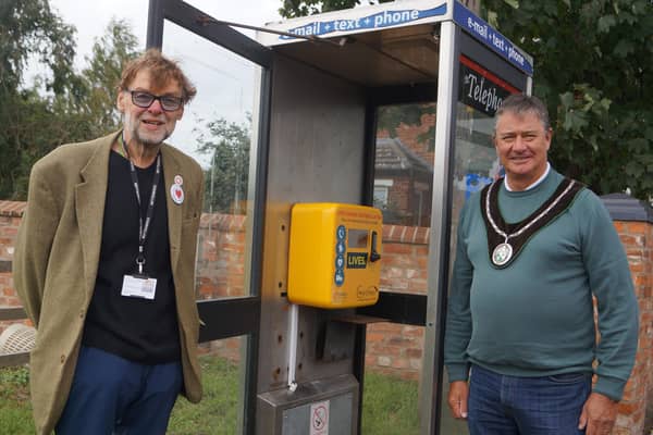 Coun Stephen Bunney, left, and Market Rasen Mayor John Matthews at the new defibrillator EMN-200510-062630001