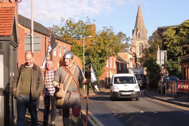 On the march. Lewis and his entourage march along Carre Street heading out of Sleaford on his 20-day re-enactment of King Harold's journey from Stamford Bridge to Hastings. EMN-200110-165027001