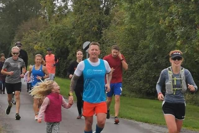 Craig Oliver of Sibsey running with his supporters, including Katie Ball who completed the entire distance with him.
