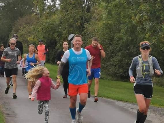 Craig Oliver of Sibsey running with his supporters, including Katie Ball who completed the entire distance with him.
