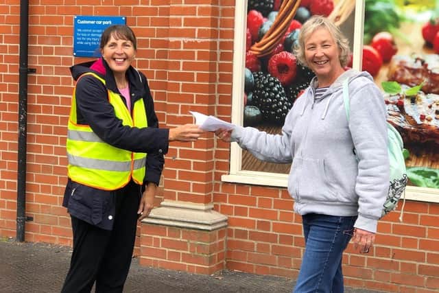 Debbie Bollard (right) handing a shopping list to one of the community support group volunteers outside the Co-op in Woodhall Spa. EMN-200710-112321001