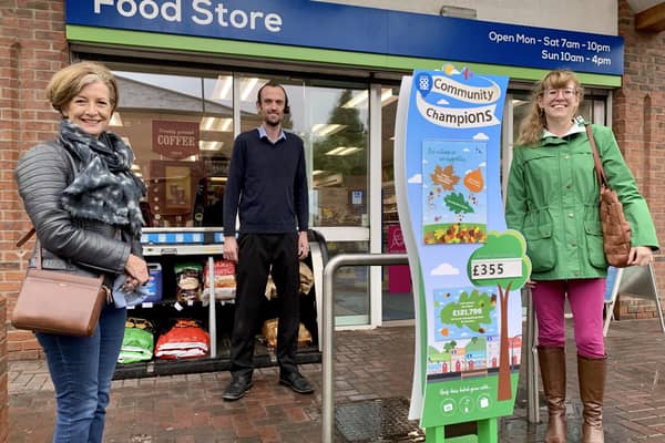 Tom Downes, store manager of Caistor Coop is flanked by Lincolnshire Cares representatives Julia Whittaker (left) and Emma Dix. EMN-200910-100316001