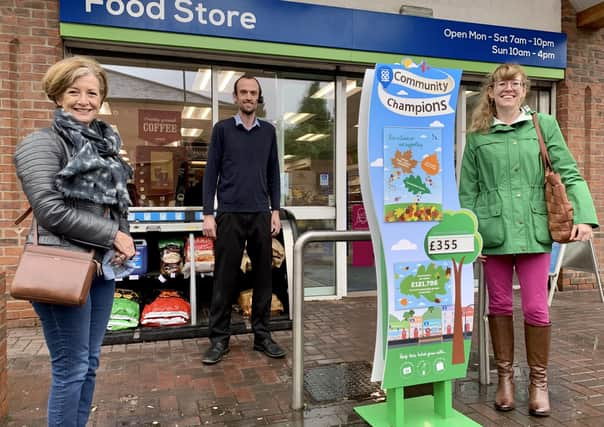 Tom Downes, store manager of Caistor Coop is flanked by Lincolnshire Cares representatives Julia Whittaker (left) and Emma Dix. EMN-200910-100316001