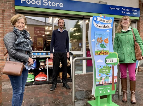 Tom Downes, store manager of Caistor Coop is flanked by Lincolnshire Cares representatives Julia Whittaker (left) and Emma Dix. EMN-200910-100316001
