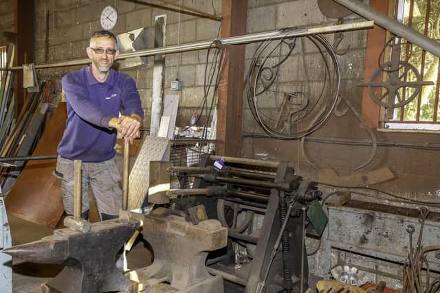 The auctioneering team's Adam Martin with some of the serious blacksmithing tools that are themselves going under the hammer.