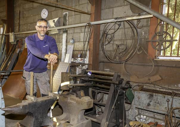 The auctioneering team's Adam Martin with some of the serious blacksmithing tools that are themselves going under the hammer.