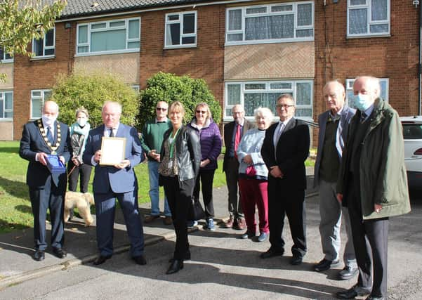 Contribution to the Environment: Neil Birkes is congratulated by councillors and local residents after receiving his award from Coun Steve England