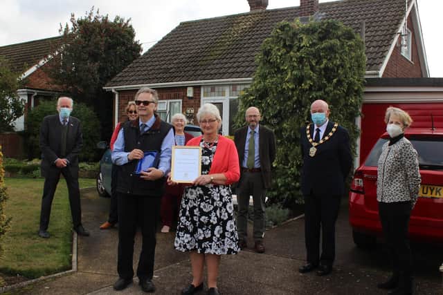 Contribution to the Environment: Neil Birkes is congratulated by councillors and local residents after receiving his award from Coun Steve England