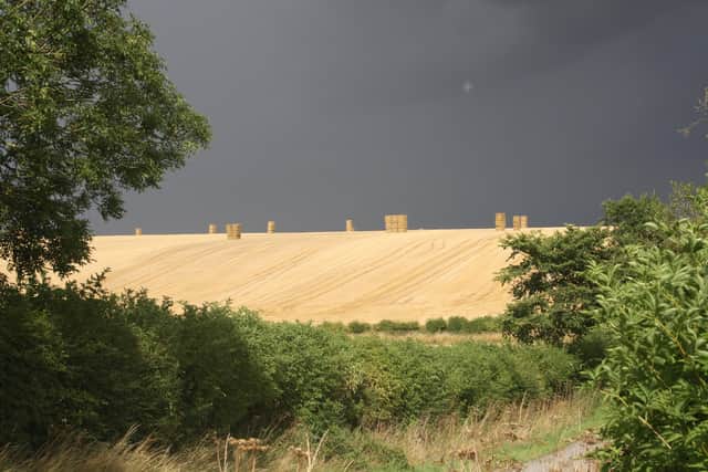 Harvest time beneath threatening skies at Binbrook. EMN-201018-162911001