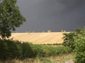 Harvest time beneath threatening skies at Binbrook. EMN-201018-162911001