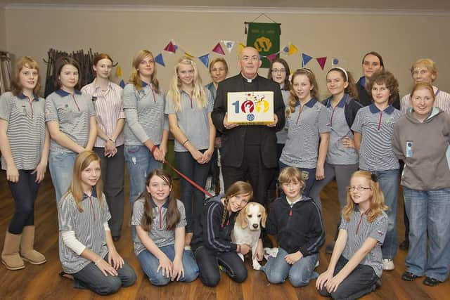 The Girl Guides make their donation to St Paul's Church 10 years ago.