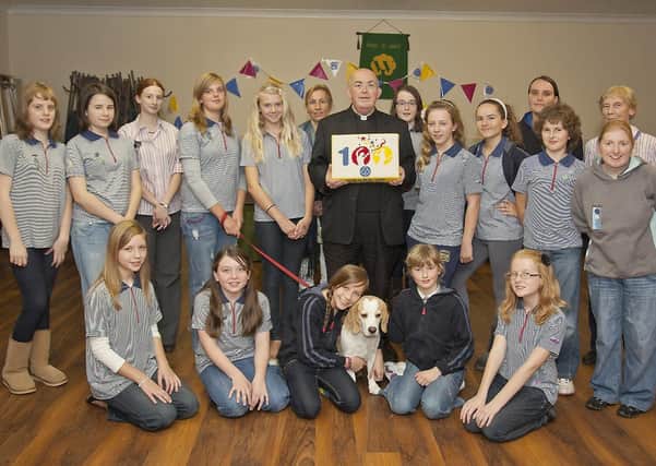 The Girl Guides make their donation to St Paul's Church 10 years ago.