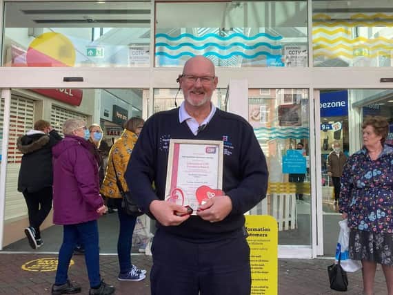 Steve Andrews, manager at the Hildreds Centre in Skegness, with two awards received for work with the community.