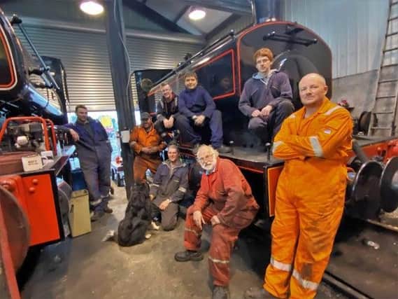 Lincolnshire Wolds Railway volunteers with ‘Maggie the Shed Dog’.