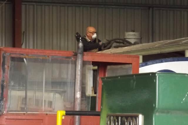 Longest serving volunteer Mick Allen, who joined on August 29 1960, cleaning the roof of the only carriage ever operated by the Nocton Estates Railway in preparation for restoration work.