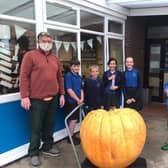 Simon Croson (left) donated his 300lb pumpkin to Caythorpe Primary School