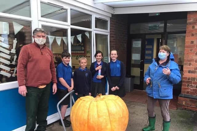 Simon Croson (left) donated his 300lb pumpkin to Caythorpe Primary School
