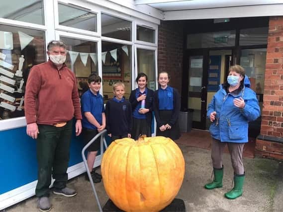 Simon Croson (left) donated his 300lb pumpkin to Caythorpe Primary School