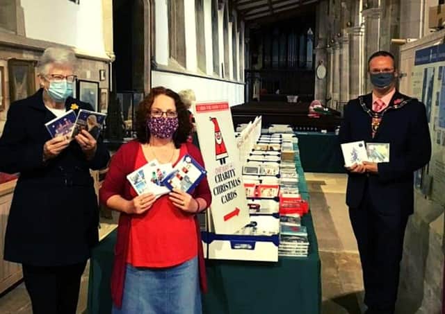 Mayor of Louth, Councillor Darren Hobson, (right) pictured at the Cards for Good Causes pop up shop.