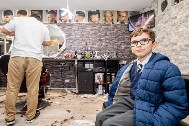 rad Burge (10) waits patiently for a haircut at L1 Barber Shop