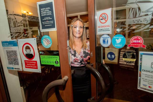 Admiral Rodney Hotel manager Hannah Melton prepares to lock the  doors for the last time before loc kdown