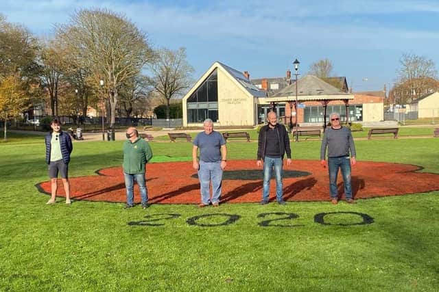 The team who painted the poppy in Tower Gardens, Skegness.
