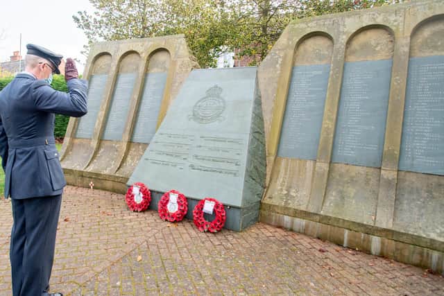 Squadron leader Robert Perry (617 Squadron stationed at RAF Coningsby)  pays his respects at the Dambusters Memorial in Royal Square, Woodhall Spa