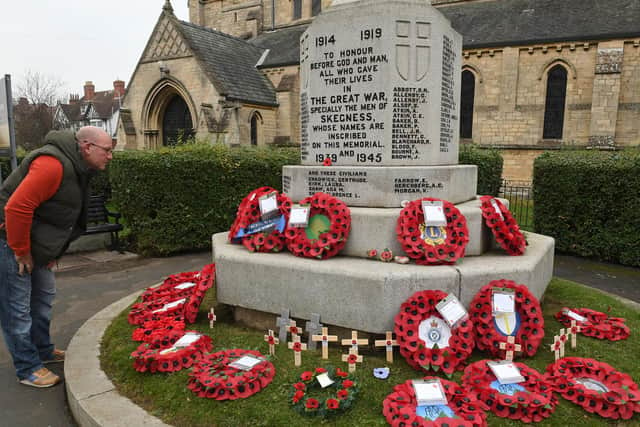 Jason Eley of Skegness looking at poppy wreaths laid at the war memorial at St Matthew's Church. His great-grandfather's name is on the memorial -  A.E.Hardy, who was killed at the First Battle of Ypres.