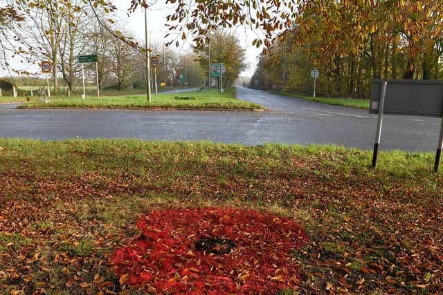 One of two poppies painted on Gunby Roundabout by Lincolnshire County Council.