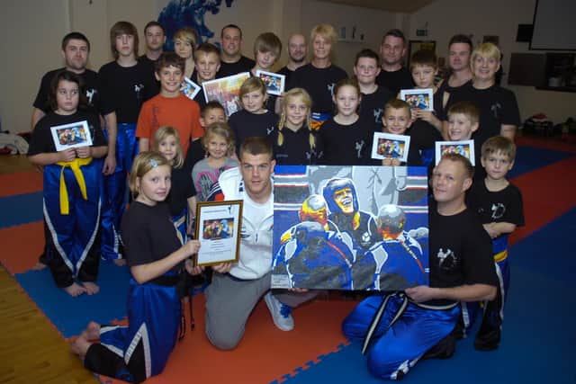 Callum Johnson signing autographs at Evolution Martial Arts 10 years ago. Pictured, front (from left) Nesta Baxter 10, Callum, and Lee Brocklesby.
