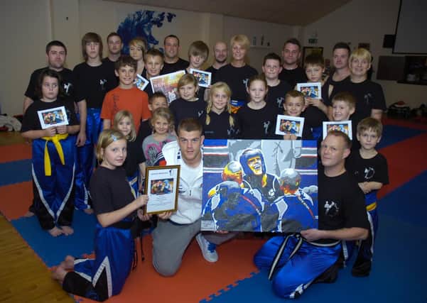 Callum Johnson signing autographs at Evolution Martial Arts 10 years ago. Pictured, front (from left) Nesta Baxter 10, Callum, and Lee Brocklesby.