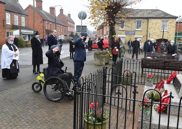 Remembrance Sunday at Heckington. L-R Eugene (Stun) Conlin laying a wreath on behalf of Royal Air Force Regiment, helped by Dave Brackley. EMN-200911-105452001