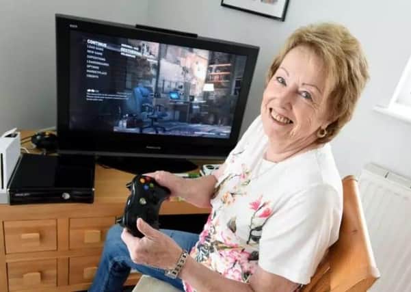 Bridget Odlin, 76, enjoying  one of her many video games.