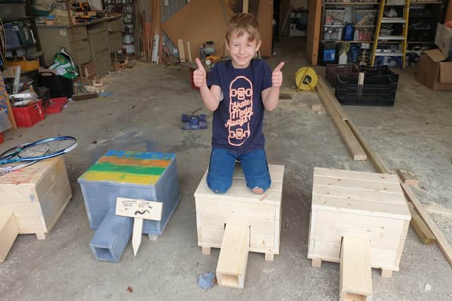 Nathaniel with his hedgehog homes