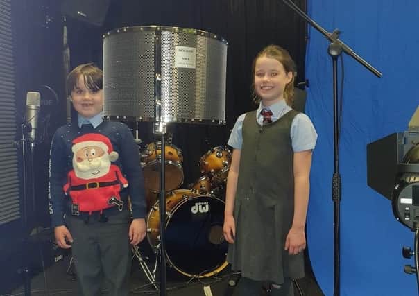 Esme and Isaac, recording at Street Star Live studios for the Christmas song. EMN-201116-112227001