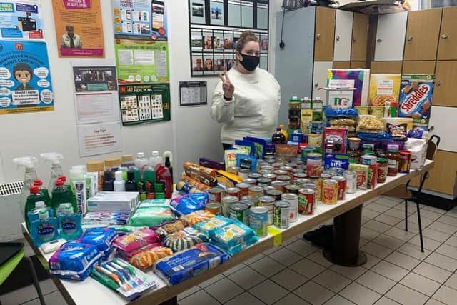 Ellen Watson in the crew room at McDonalds with a table groaning under the gifts for Sleaford's food bank. EMN-201120-153253001
