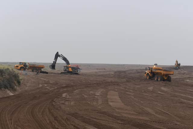 Environment Agency moving sand on Winthorpe beach.