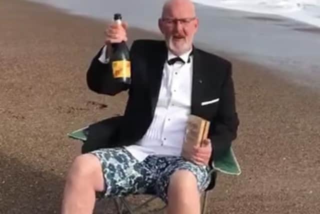 Steve Andrews, manager of the Hildreds Centre in Skegness, on the beach celebrating winning the retail industry's 'Oscar' - the Purple Apple award.